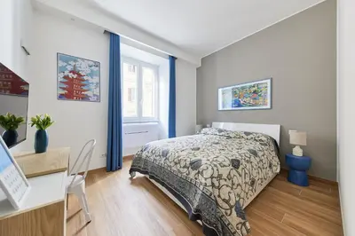 a bedroom with a bed and a desk and a window at iFlat Lovely Modern Apartment in Rome
