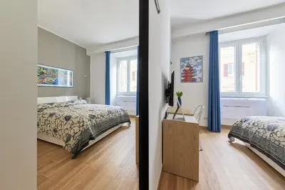 a bedroom with two beds and a window at iFlat Lovely Modern Apartment in Rome