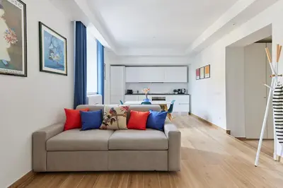 a living room with a couch with colorful pillows at iFlat Lovely Modern Apartment in Rome