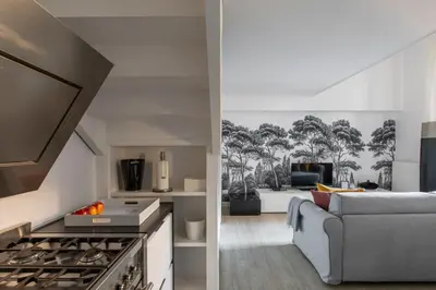 a kitchen and a living room with a couch at iFlat Historic flat in campo de fiori in Rome