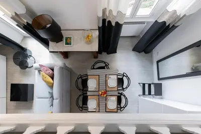 a kitchen with white walls and a ceiling with windows at iFlat Historic flat in campo de fiori in Rome