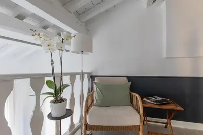 a room with a chair and a table with a plant at iFlat Historic flat in campo de fiori in Rome