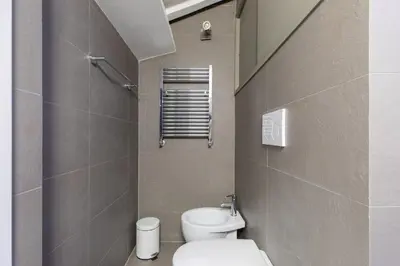 a small bathroom with a toilet and a sink at iFlat Historic flat in campo de fiori in Rome