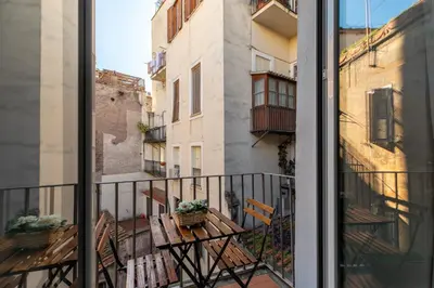 a balcony with a table and chairs on a balcony at iFlat Historic flat in campo de fiori in Rome