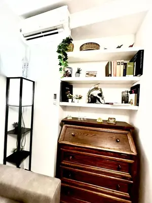 a room with a chest of drawers and shelves at 150 meters from the Colosseum - Appartmento Gladiatore in Rome
