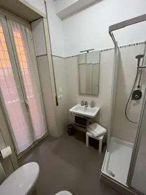a bathroom with a toilet and a sink and a shower at Monti Deluxe Apartment in Rome