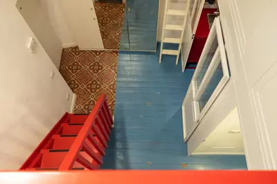 a staircase in a house with red and blue stairs at Farina 36 in Rome