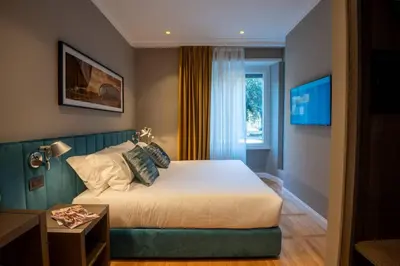 a hotel room with a bed and a window at Domus 213 Guest House - Boutique Suites in Auditorium, MAXXI, Villa Borghese, Piazza del Popolo in Rome