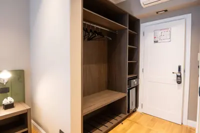 a walk in closet with a white door at Domus 213 Guest House - Boutique Suites in Auditorium, MAXXI, Villa Borghese, Piazza del Popolo in Rome