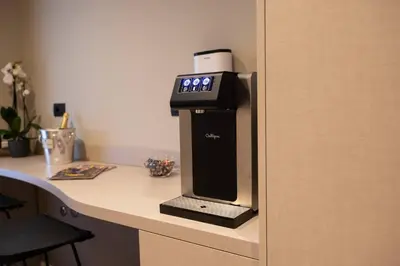 a coffee machine sitting on top of a desk at Domus 213 Guest House - Boutique Suites in Auditorium, MAXXI, Villa Borghese, Piazza del Popolo in Rome