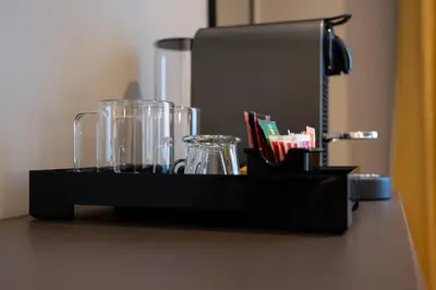 a black tray with glasses and a mirror on a table at Domus 213 Guest House - Boutique Suites in Auditorium, MAXXI, Villa Borghese, Piazza del Popolo in Rome
