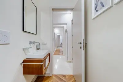 a bathroom with a sink and a mirror at BDC - The Platinum 2-Bdr apt @Spanish Steps in Rome