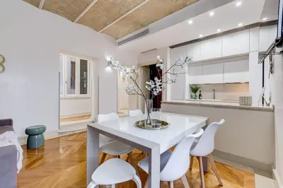 a dining room with a white table and white chairs at BDC - The Platinum 2-Bdr apt @Spanish Steps in Rome