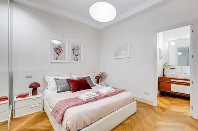 a white bedroom with a bed and a sink at BDC - The Platinum 2-Bdr apt @Spanish Steps in Rome