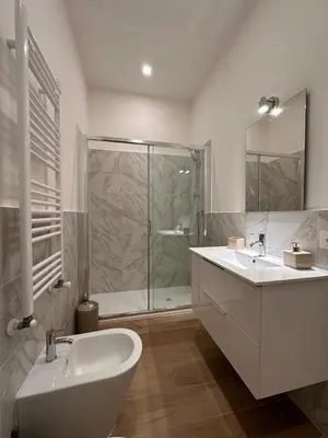 a bathroom with a tub and a sink and a shower at Domus Iulius in Rome