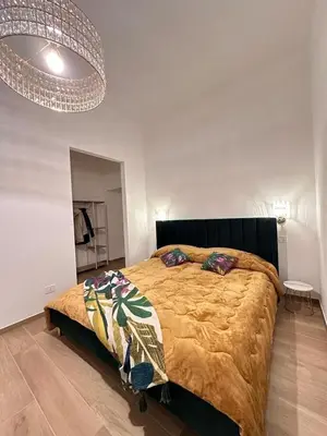 a bedroom with a bed and a chandelier at Domus Iulius in Rome