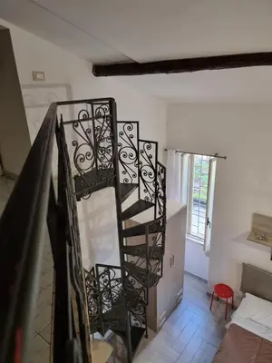 a spiral staircase in a room with a stair case at Loftiense Roma in Rome