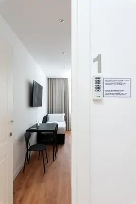 a room with a table and a bed and a bedroom at Roma Mia in Trastevere in Rome