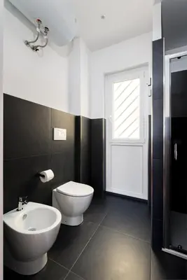 a bathroom with a white toilet and a sink at Roma Mia in Trastevere in Rome