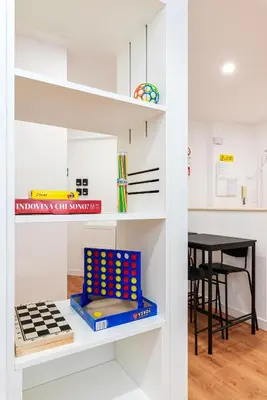 a room with a book shelf with dominoes at Roma Mia in Trastevere in Rome