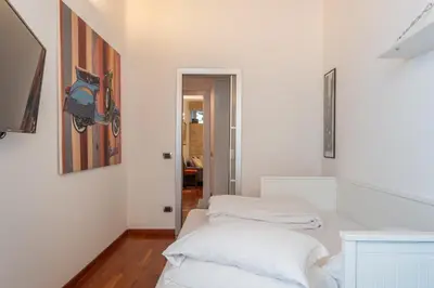 a white room with two beds in it at PgrHome Boschetto in Rome