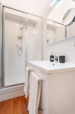 a white bathroom with a shower and a sink at PgrHome Boschetto in Rome