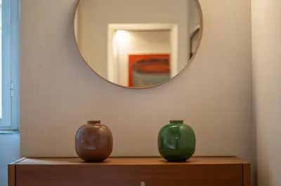 two vases sitting on a table in front of a mirror at PgrHome Boschetto in Rome