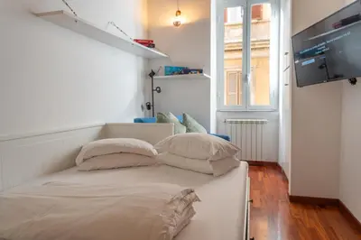 a white bed with pillows on it in a room at PgrHome Boschetto in Rome