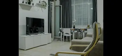 a living room with a television and a table with chairs at Monti Exclusive Apartment in Rome