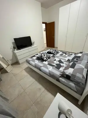 a bedroom with a bed and a flat screen tv at Monti Exclusive Apartment in Rome