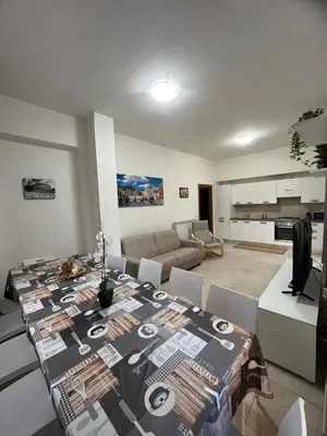 a kitchen and living room with a dining room table at Monti Royal Apartment in Rome