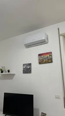 a white room with a television and a white wall at Monti Royal Apartment in Rome