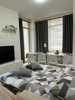 a large bedroom with two beds and a table at Monti Royal Apartment in Rome