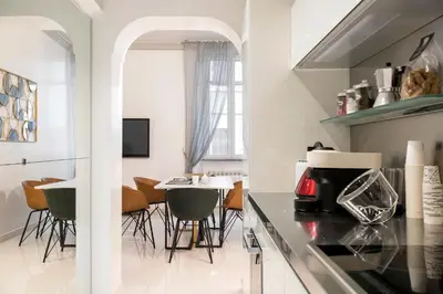 a kitchen and dining room with a table and chairs at Angelique Boutique in Rome