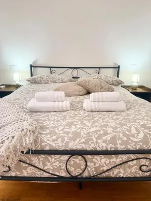 a bed with two pillows on top of it at Volupta's House Janiculum Hill in Rome