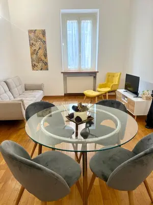 a living room with a glass table and chairs at Volupta's House Janiculum Hill in Rome