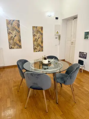 a dining room with a glass table and chairs at Volupta's House Janiculum Hill in Rome