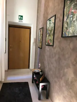 a hallway with a brown door and a black table at Boncompagni Suite Roma in Rome