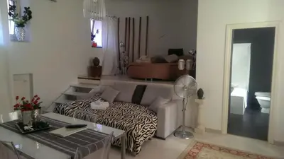 a living room with a zebra print couch and a table at Boncompagni Suite Roma in Rome