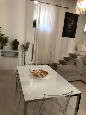 a white table and chairs in a living room at Boncompagni Suite Roma in Rome