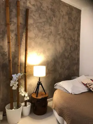 a bedroom with a bed and a lamp and flowers at Boncompagni Suite Roma in Rome