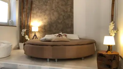 a bed in a room with two lamps and a bed sidx sidx sidx at Boncompagni Suite Roma in Rome