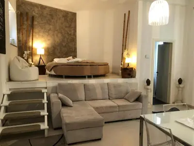 a living room with a couch and a bed at Boncompagni Suite Roma in Rome