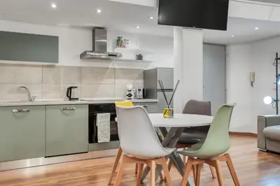 a kitchen and dining room with a table and chairs at ATRHOME - Canova Essential in Rome
