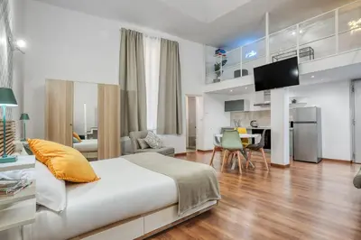 a bedroom with a bed and a living room at ATRHOME - Canova Essential in Rome