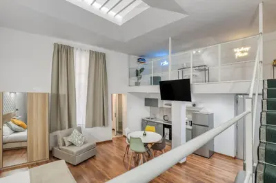 a white living room with a table and a tv at ATRHOME - Canova Essential in Rome
