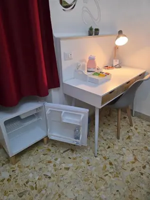 an office with a desk with an open refrigerator at GuestHouse Aurora ML in Rome