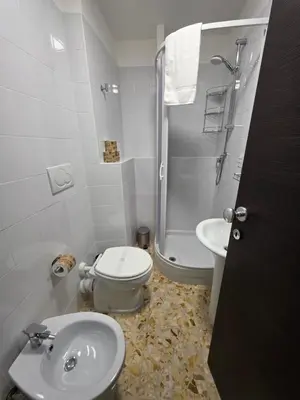 a bathroom with a toilet and a sink and a shower at GuestHouse Aurora ML in Rome