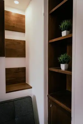 a room with wooden shelves with two potted plants at GuestHouse Aurora ML in Rome
