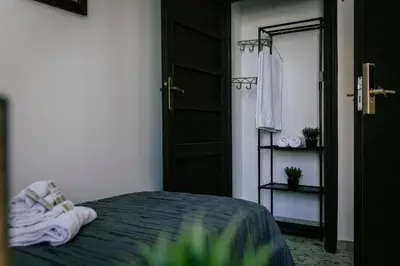 a bedroom with a bed and a mirror and a door at GuestHouse Aurora ML in Rome